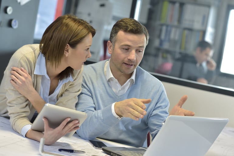 Business people in office working on laptop and tablet