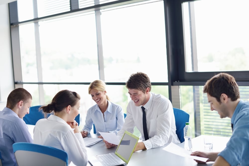 Group of happy young  business people in a meeting at office